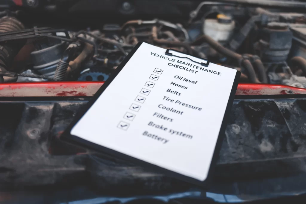 Close-up view of a clipboard with a vehicle maintenance checklist